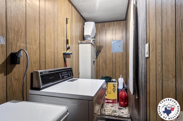 203 Pleasant Vly, Texarkana, AR 71854 - laundry room featuring wooden walls, washer and clothes dryer, and a textured ceiling