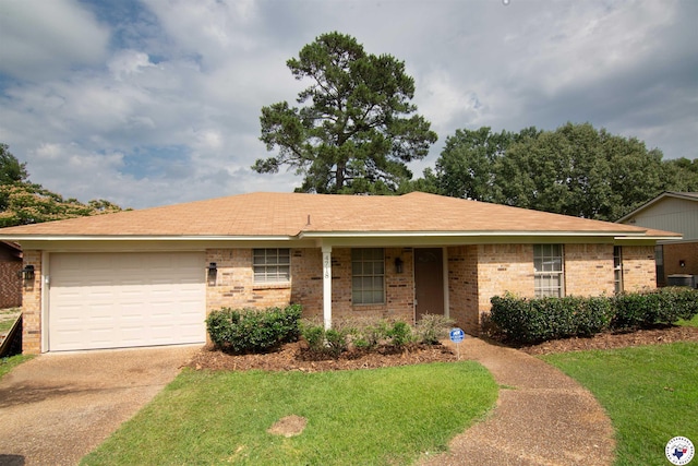 4718 Charleston St, Texarkana, AR 71854 - ranch-style house featuring driveway, brick siding, an attached garage, and a front yard