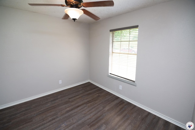 4718 Charleston St, Texarkana, AR 71854 - empty room featuring dark wood-style flooring, a ceiling fan, baseboards, and a textured ceiling