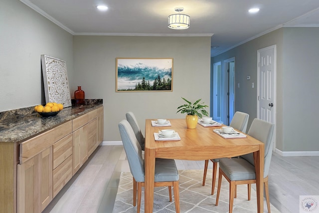 dining space featuring crown molding