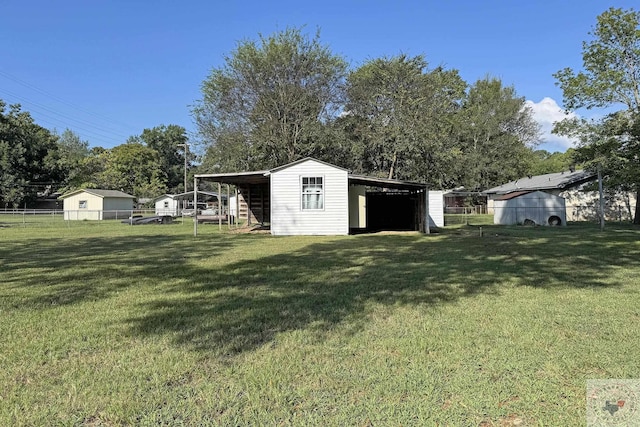 view of yard featuring a carport and an outdoor structure