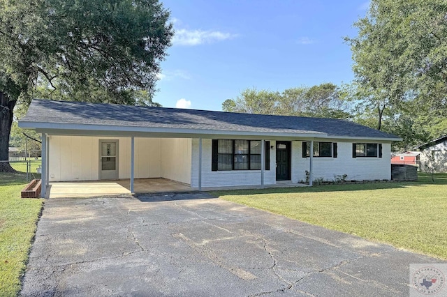 ranch-style house featuring a front yard and a carport