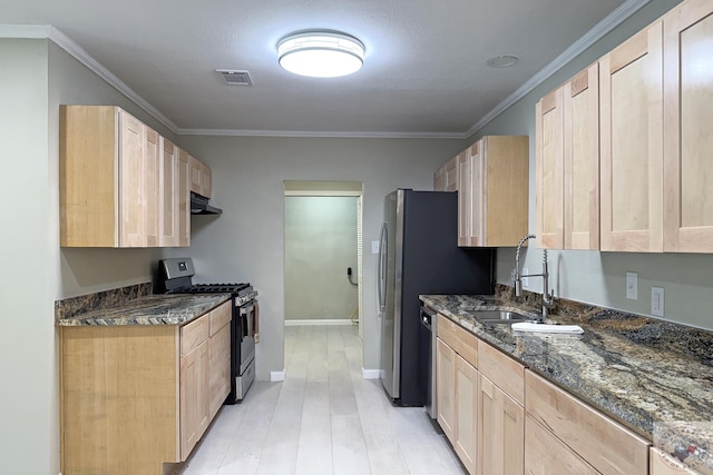 kitchen with light brown cabinetry, stainless steel gas range, sink, ornamental molding, and dark stone counters