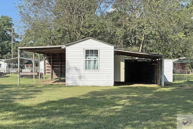 view of outdoor structure featuring a yard and a carport