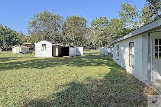 view of yard with an outbuilding and a carport