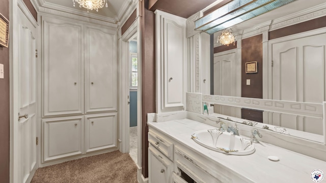 bathroom featuring crown molding, vanity, and a notable chandelier