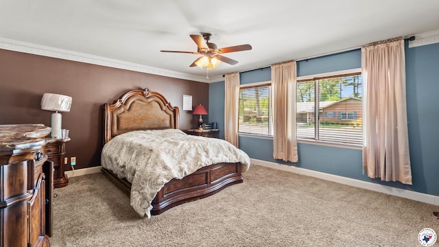 carpeted bedroom with crown molding, baseboards, and ceiling fan