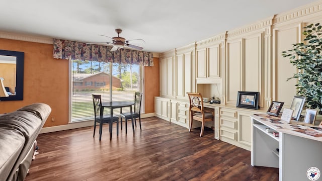 interior space with dark wood-type flooring, built in study area, baseboards, and ceiling fan