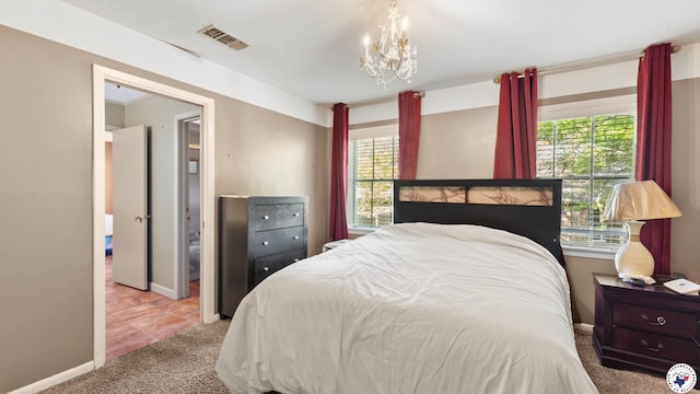 carpeted bedroom with baseboards, a chandelier, and visible vents