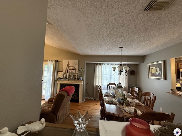567 Mc 257, Texarkana, AR 71854 - dining area featuring a textured ceiling, light wood-type flooring, and a chandelier