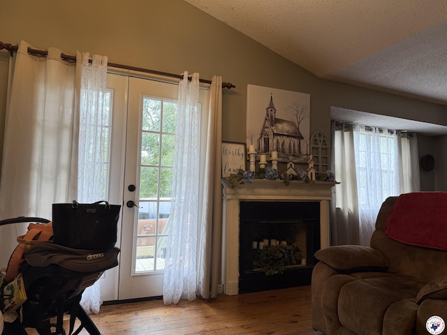 567 Mc 257, Texarkana, AR 71854 - living room featuring lofted ceiling, wood-type flooring, a fireplace, and a textured ceiling