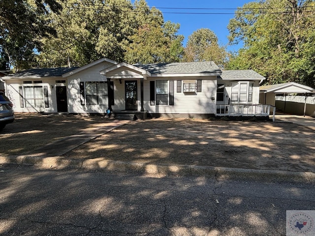 single story home featuring a carport