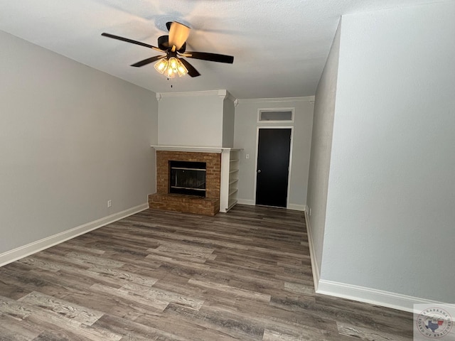 unfurnished living room with ceiling fan, wood-type flooring, and a fireplace