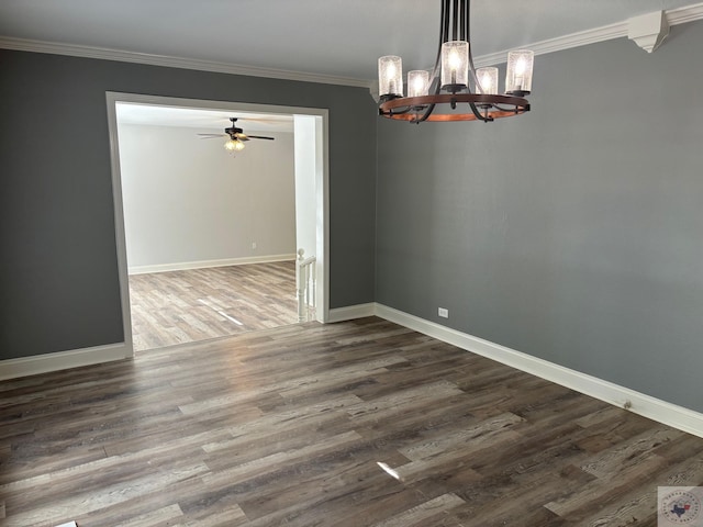 unfurnished dining area featuring hardwood / wood-style flooring, crown molding, and ceiling fan with notable chandelier