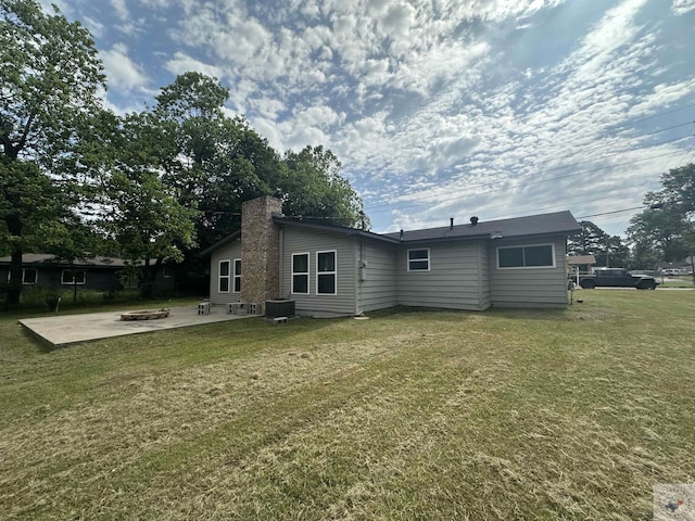 back of property featuring a patio area, a lawn, and cooling unit