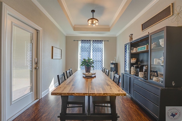 80 Chester Field Cir, Texarkana, TX 75503 - dining room featuring dark wood-style floors, a tray ceiling, ornamental molding, and baseboards