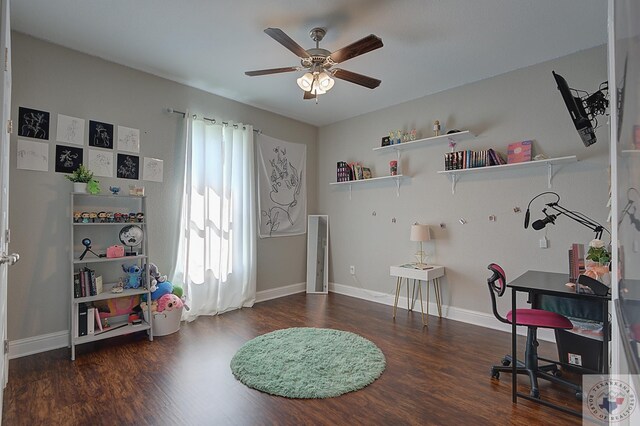 recreation room with ceiling fan, baseboards, and wood finished floors