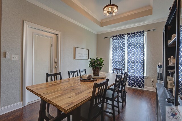 dining area featuring a wealth of natural light, crown molding, a raised ceiling, and dark wood-type flooring