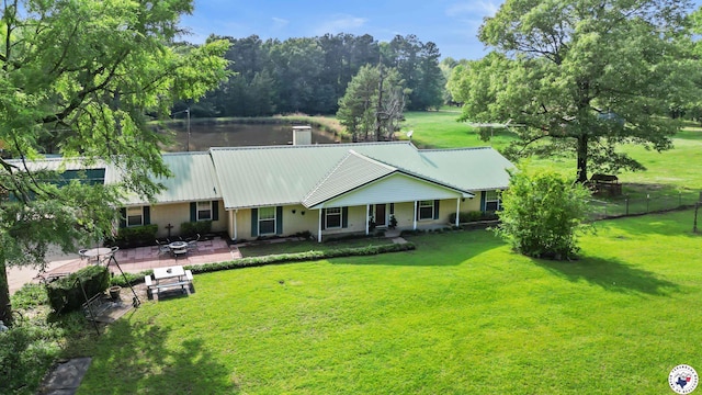 1539 Vanderbilt Rd, Texarkana, AR 71854 - rear view of house with fence, a patio, metal roof, a lawn, and a water view