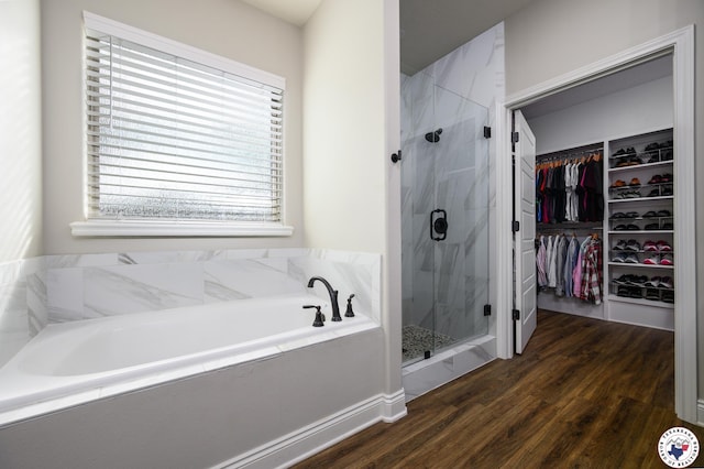 3401 Skyline Blvd, Texarkana, TX 75503 - bathroom featuring a marble finish shower, a walk in closet, a garden tub, and wood finished floors