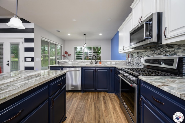 3401 Skyline Blvd, Texarkana, TX 75503 - kitchen with appliances with stainless steel finishes, a sink, blue cabinetry, wood finished floors, and white cabinets