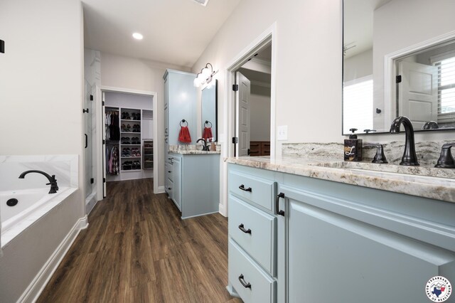 3401 Skyline Blvd, Texarkana, TX 75503 - full bath with vanity, wood finished floors, a bath, and a walk in closet