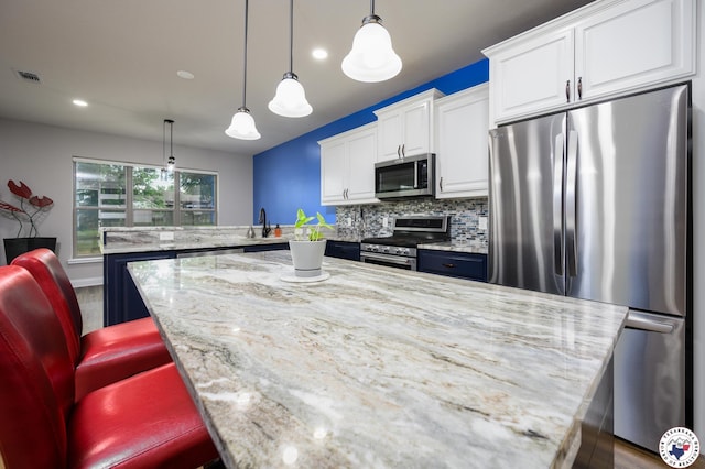 3401 Skyline Blvd, Texarkana, TX 75503 - kitchen with appliances with stainless steel finishes, a peninsula, light stone countertops, a center island, and white cabinetry