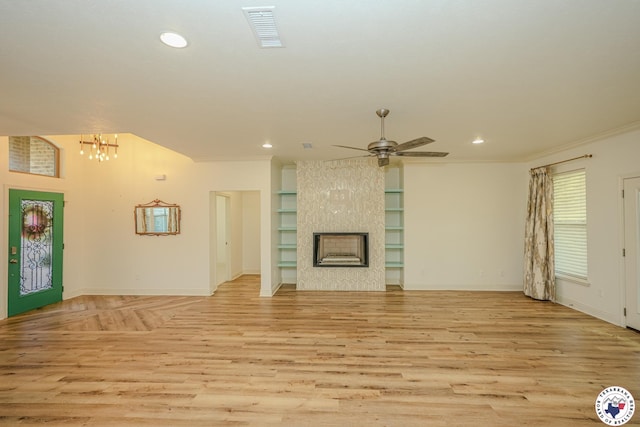 10 King Ranch Rd, Texarkana, TX 75503 - unfurnished living room featuring light wood-style floors, a ceiling fan, recessed lighting, ornamental molding, and a chandelier