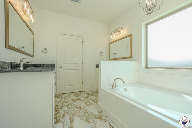 10 King Ranch Rd, Texarkana, TX 75503 - full bathroom with marble finish flooring, vanity, a bath, and a chandelier