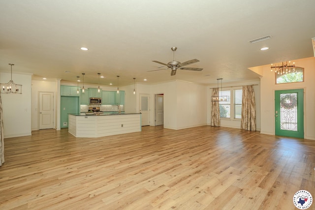10 King Ranch Rd, Texarkana, TX 75503 - unfurnished living room with a chandelier, recessed lighting, light wood-type flooring, ceiling fan, and ornamental molding
