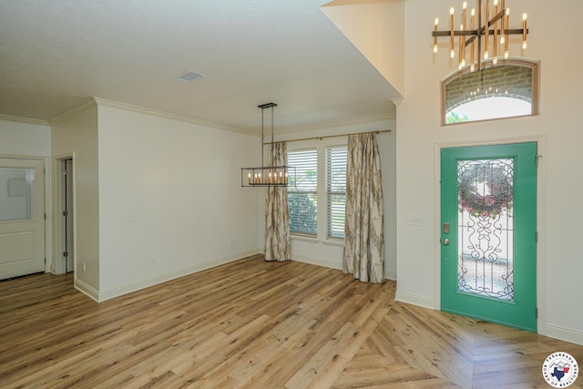 10 King Ranch Rd, Texarkana, TX 75503 - entrance foyer featuring a chandelier, ornamental molding, and parquet flooring