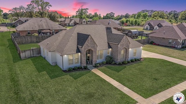 10 King Ranch Rd, Texarkana, TX 75503 - view of front of house with driveway, a residential view, a fenced backyard, and stucco siding