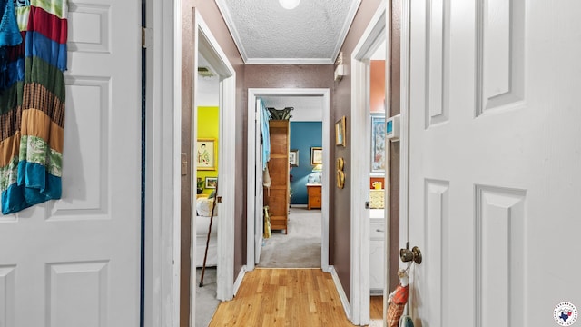 6209 N Park Rd, Texarkana, TX 75503 - hall with light wood-type flooring, a textured ceiling, crown molding, and baseboards