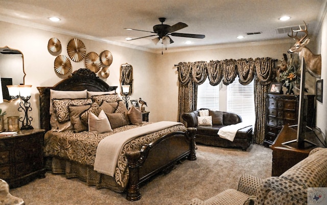 carpeted bedroom with ceiling fan and ornamental molding