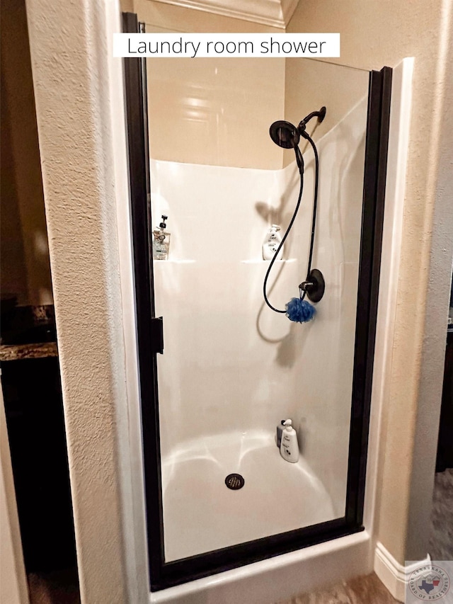 bathroom featuring a shower and ornamental molding