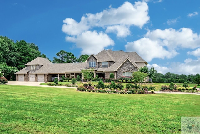 craftsman house with a garage and a front yard