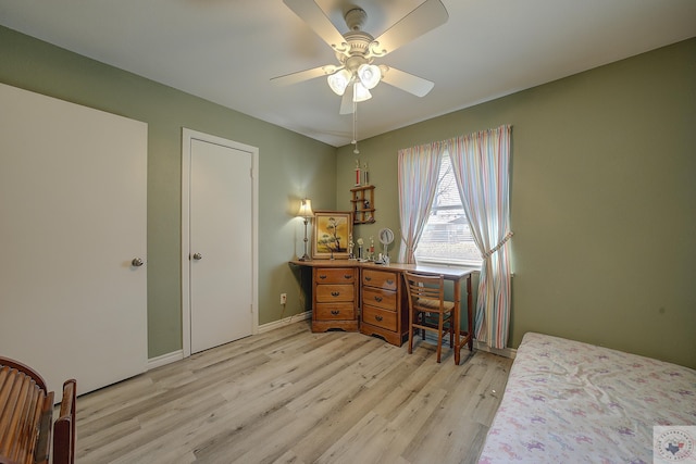 home office with light wood-style flooring, baseboards, and ceiling fan