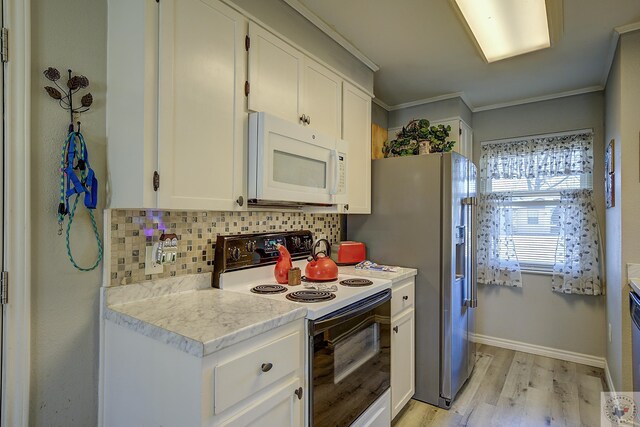 kitchen with decorative backsplash, light countertops, white microwave, and range with electric stovetop