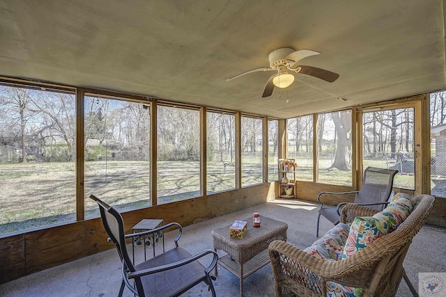 sunroom featuring a ceiling fan