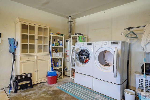 washroom with separate washer and dryer, laundry area, and water heater