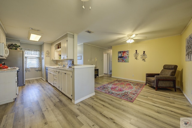 kitchen featuring visible vents, open shelves, a sink, light countertops, and white cabinetry