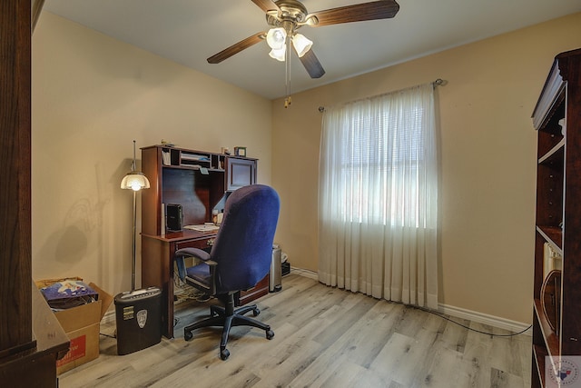 office space featuring baseboards, wood finished floors, and a ceiling fan