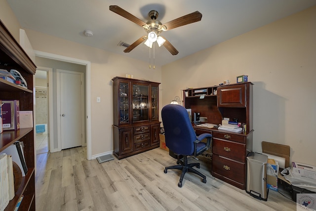 home office with baseboards, light wood-style floors, and a ceiling fan