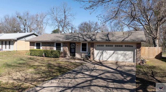 single story home featuring driveway, fence, a front yard, an attached garage, and brick siding