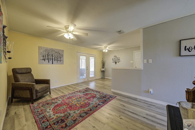 sitting room featuring wood finished floors, visible vents, and french doors