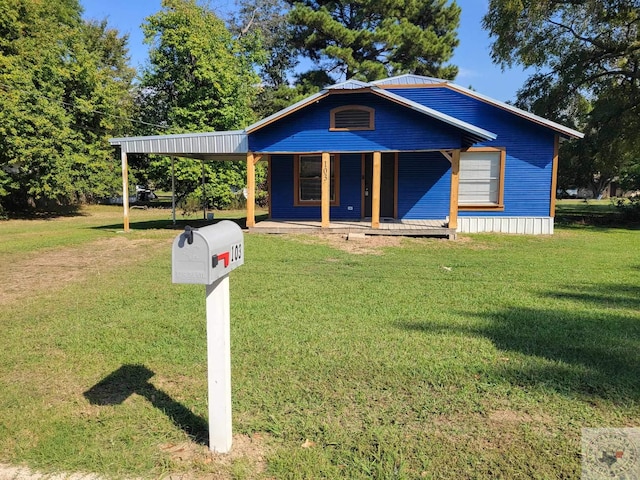 view of front facade featuring a carport, a porch, and a front yard