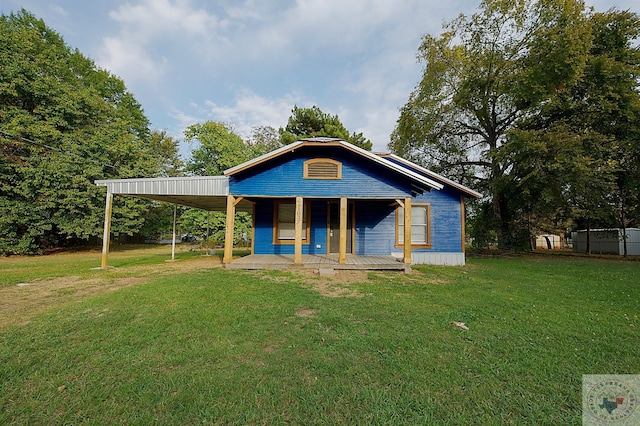 view of front facade with a carport and a front yard