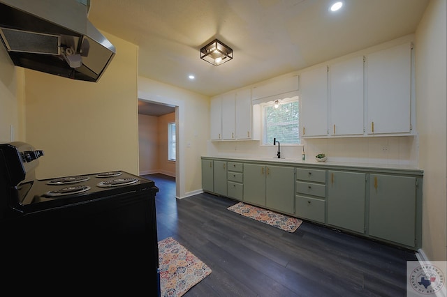 kitchen with extractor fan, dark wood-type flooring, black range with electric stovetop, sink, and green cabinetry