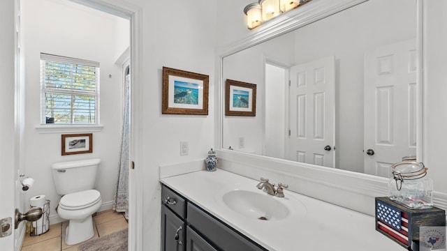 full bath featuring baseboards, vanity, toilet, and tile patterned floors