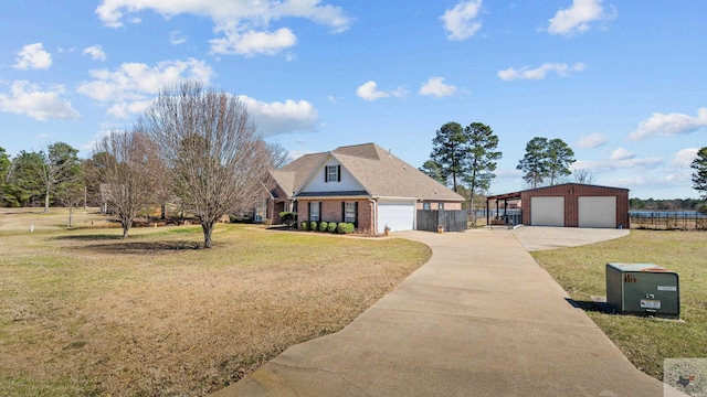 view of front of property with a garage, brick siding, fence, driveway, and a front yard